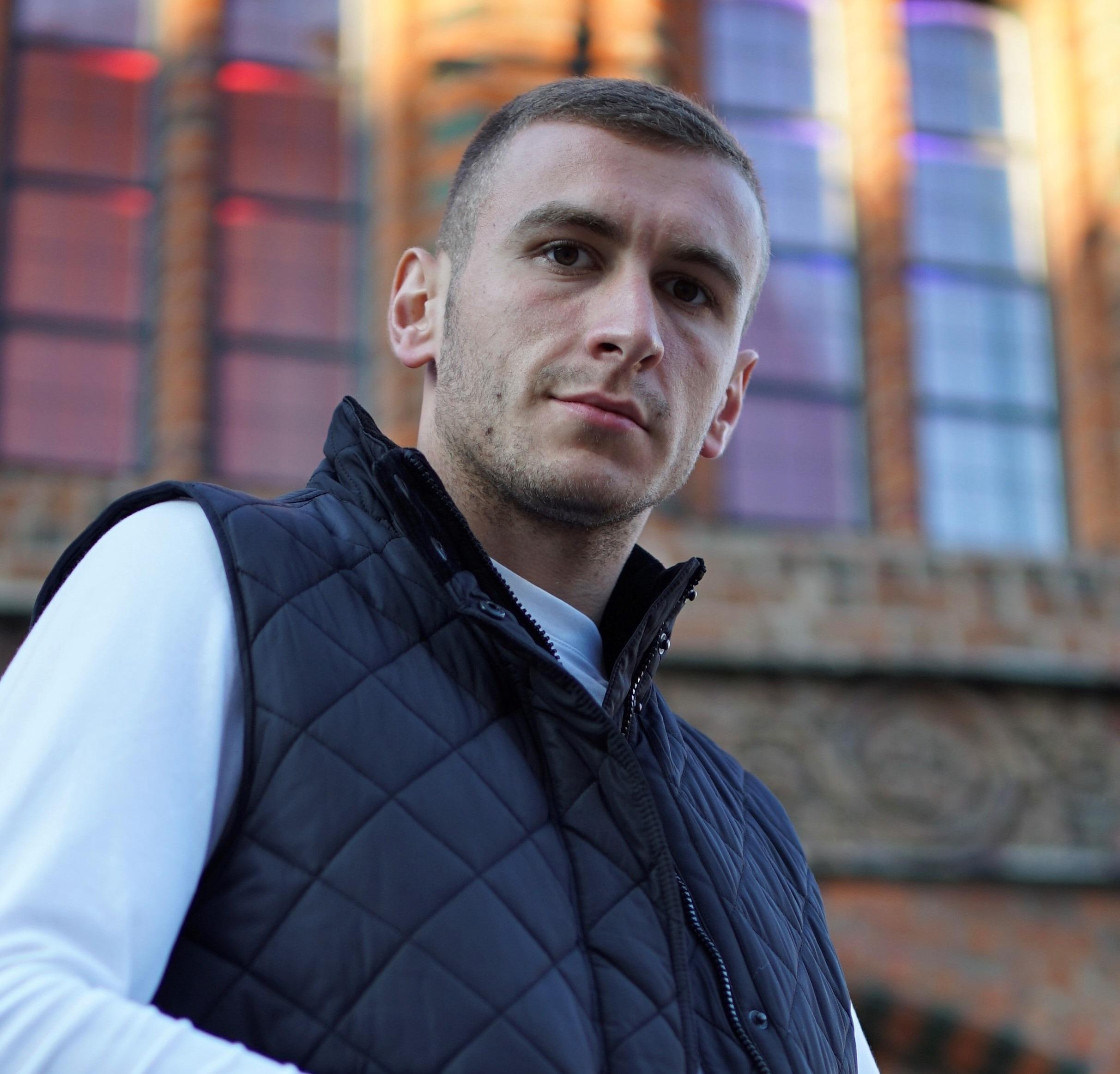 Hamza Rebronja - Hamza Rebronja standing in front of a brick villa.